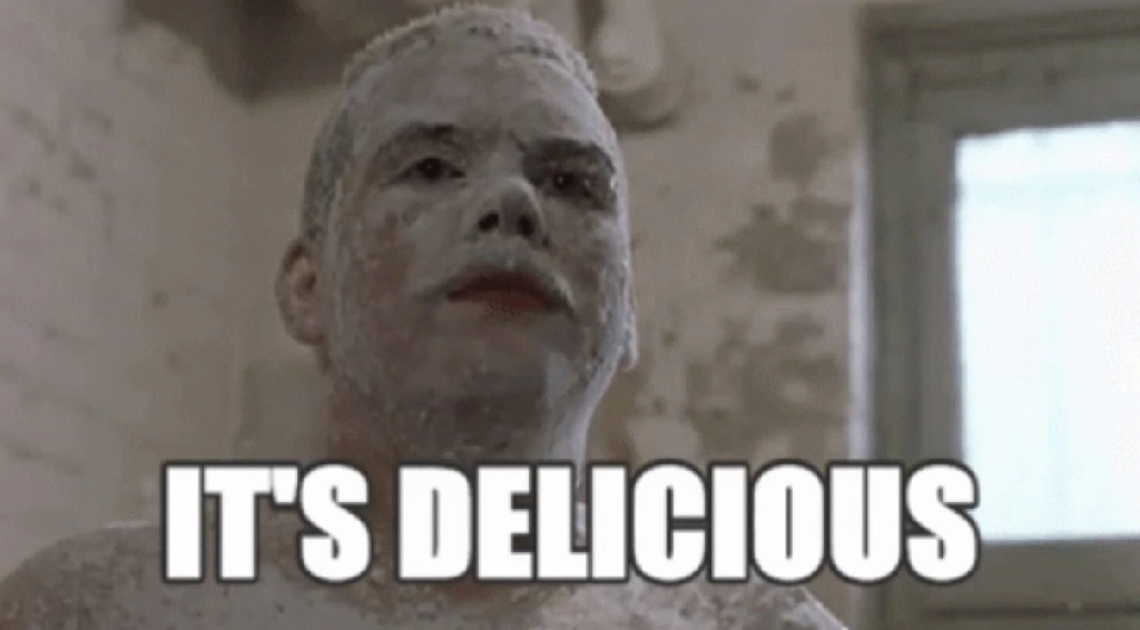 Farva from Super Troopers covered in powdered sugar and saying ‘it’s delicious’